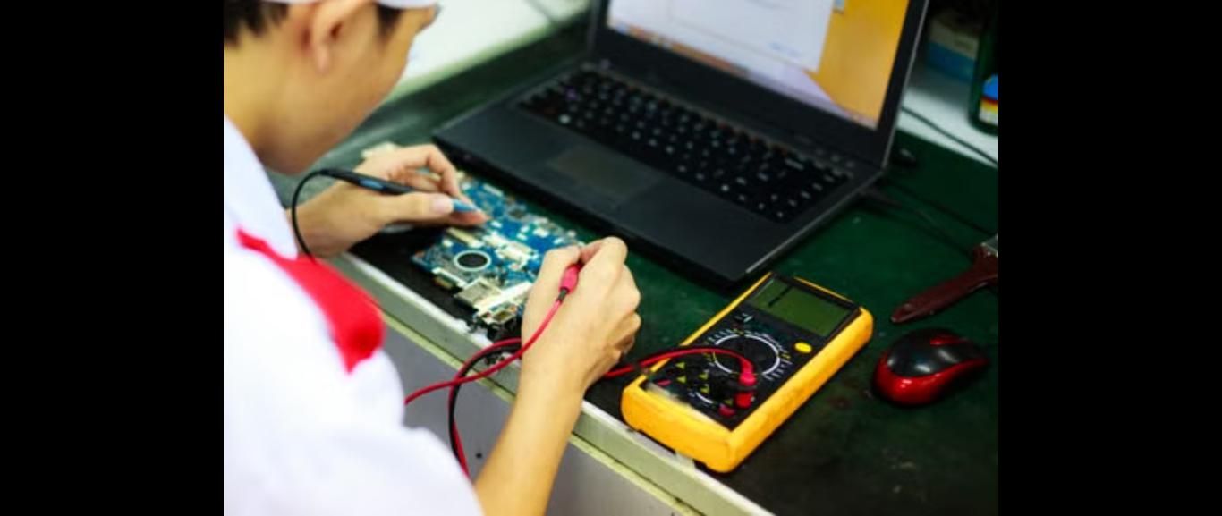 BLU TECH technician servicing a laptop motherboard