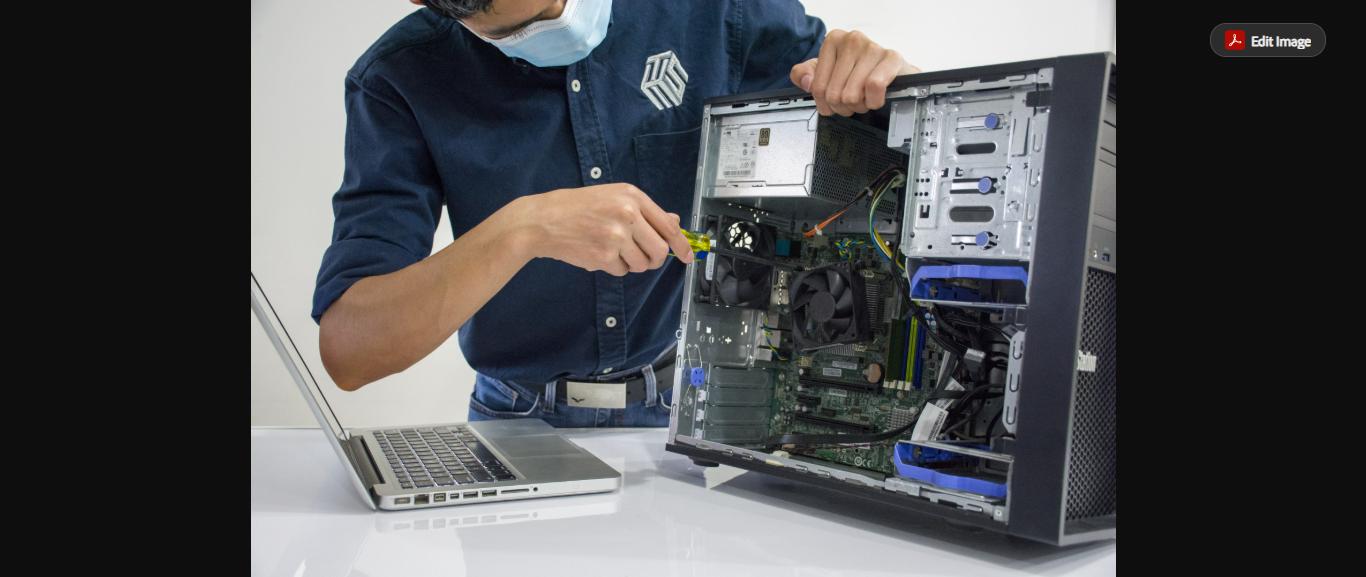 BLU TECH technician servicing a laptop and desktop computer